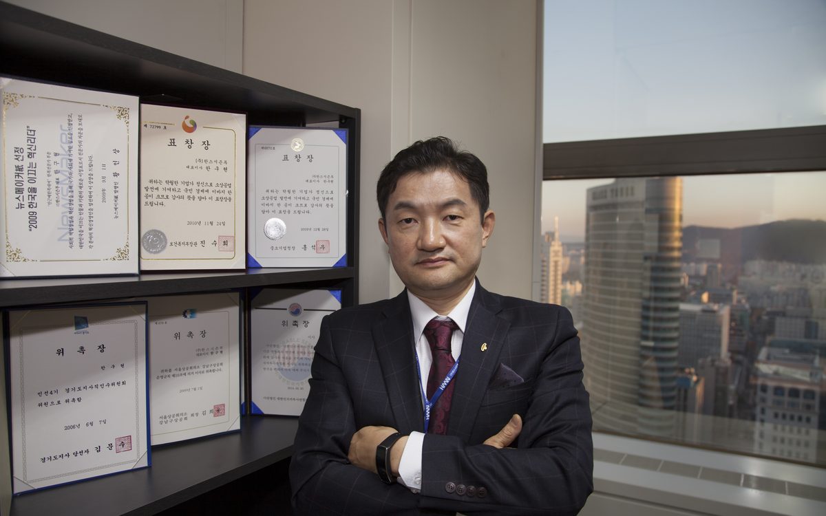 Seungbum Han, CEO, in front of his award certificates